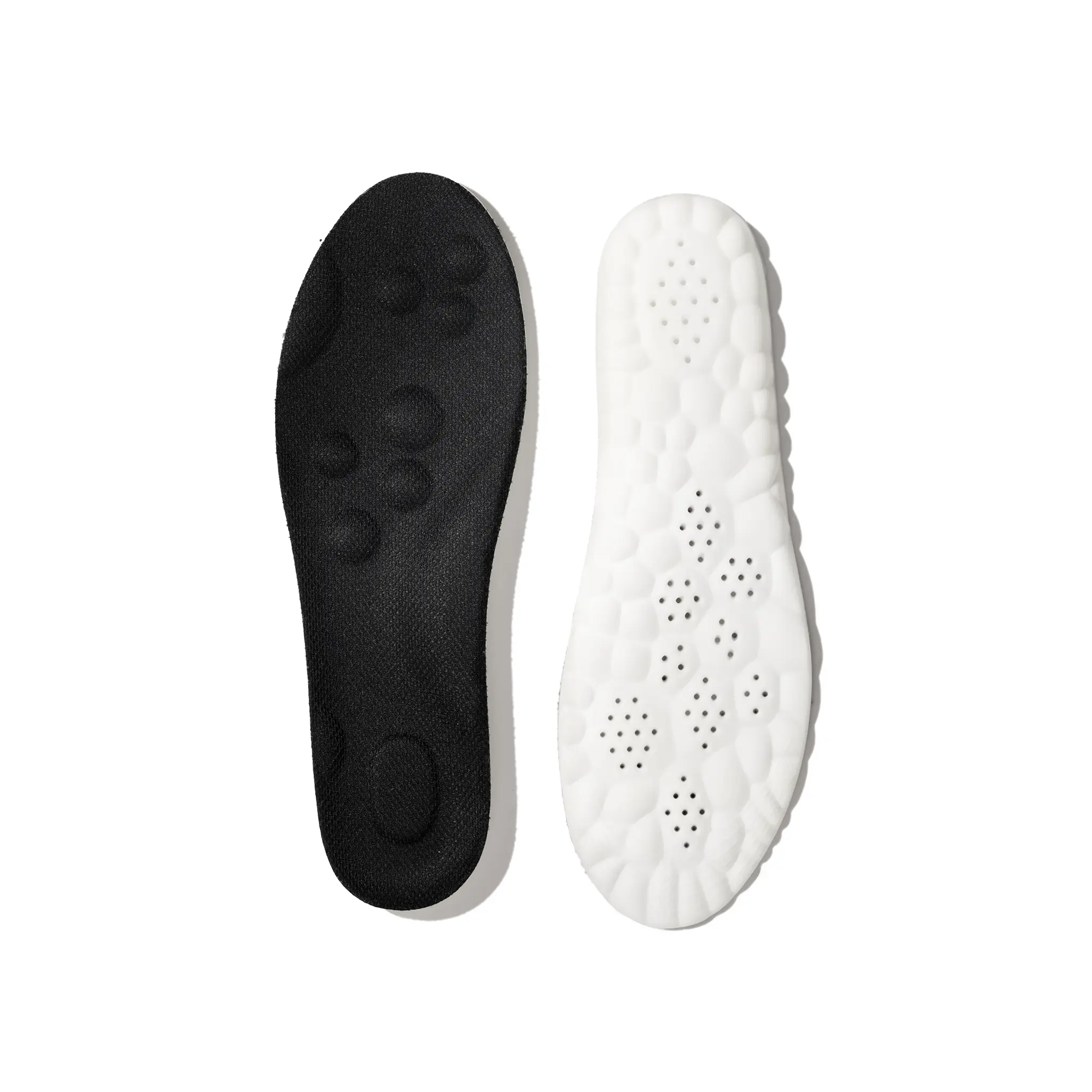 Black and white shoe insoles on a white background