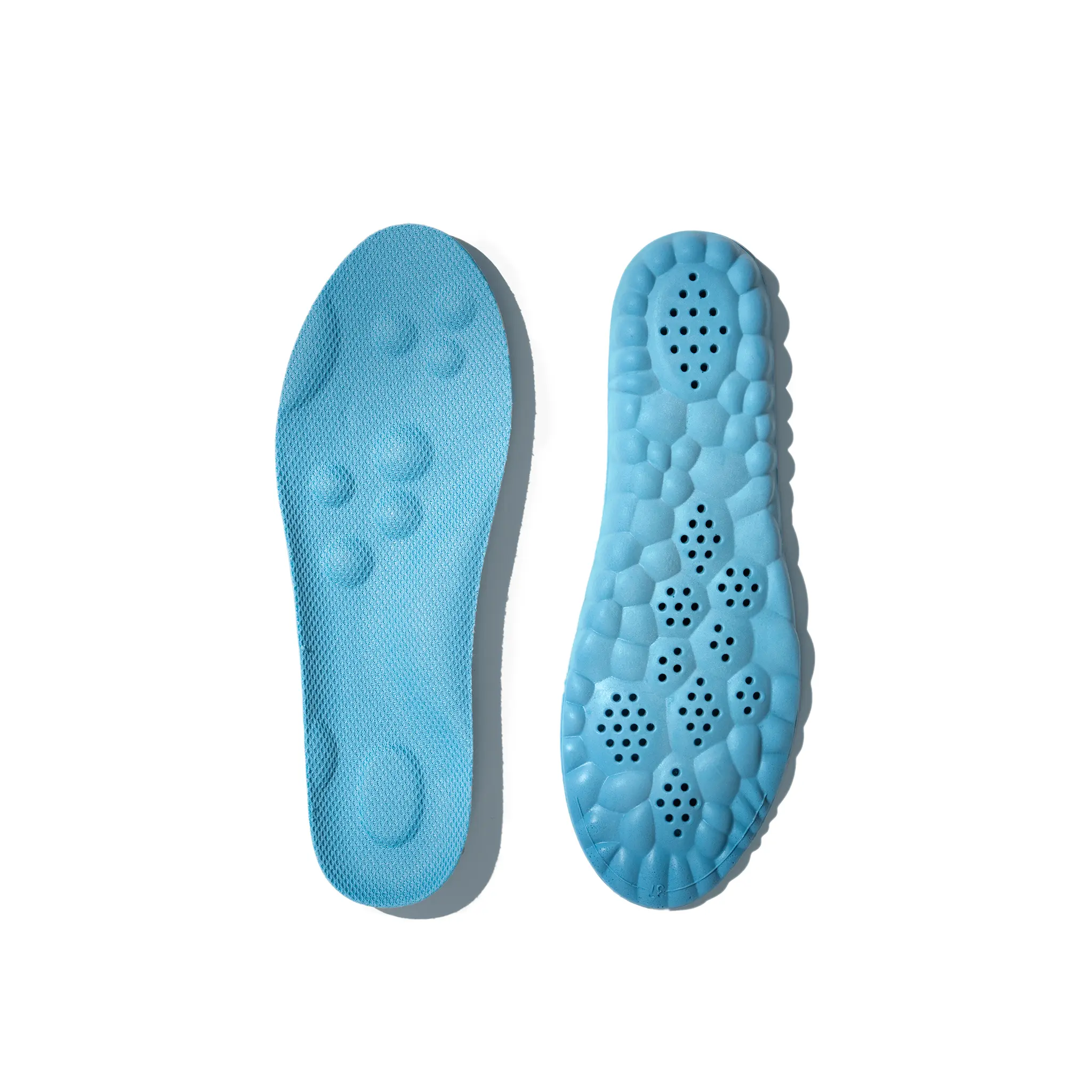 Blue shoe insoles with textured surface on a white background