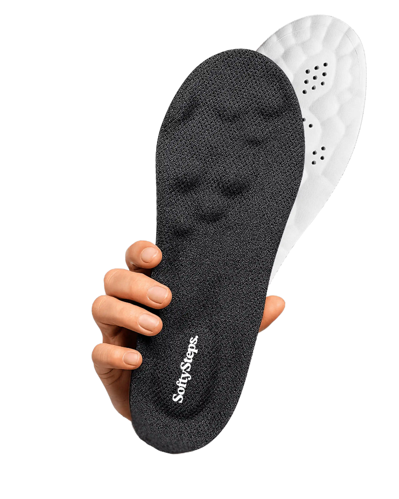 Black and white shoe insole held by a hand on a white background